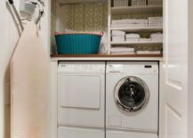 open doors closet laundry room white washer and dryer hanging ironing board shelves baskets