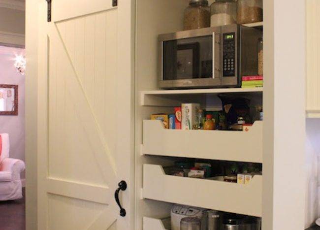 pantry closet with sliding barn door white shelving