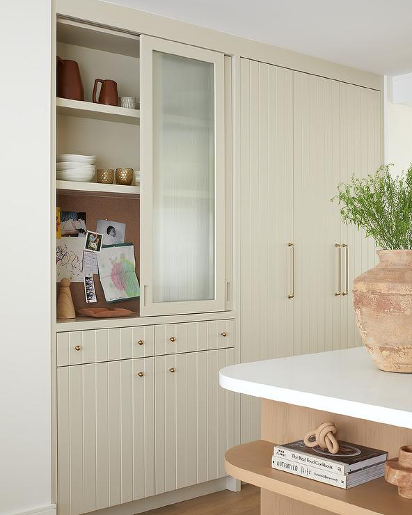 command center hidden behind frosted glass beige cabinetry kitchen modern