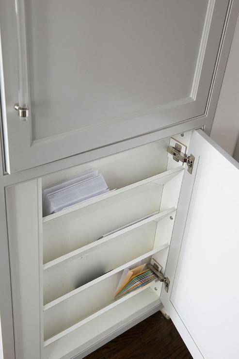 hidden slanted mail holders inside cupboard grey white