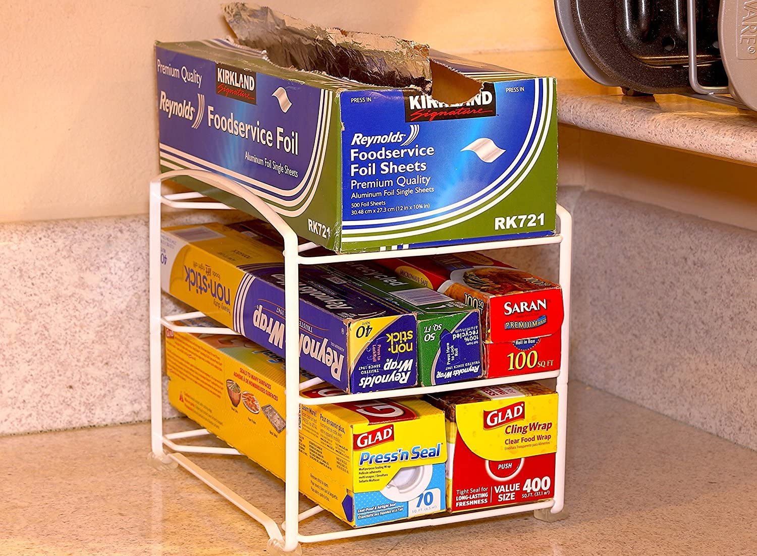 wire holder on counter with plastic wrap aluminum foil