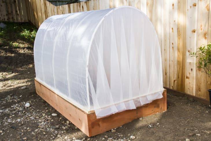 hoop garden bed covered white fabric