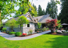 front of house on grass large yard modern landscaping cement pathway sidewalk trees