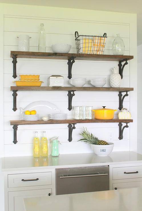 open shelves kitchen brown wrought iron brackets yellow dishes 