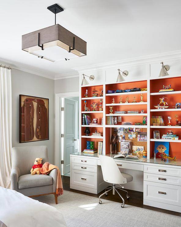 white bookshelf with orange backing boys room chair modern light fixture armchair carpet wall sconce lighting