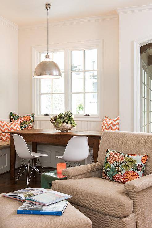 orange accents in living space sitting chair table white chairs hanging pendant