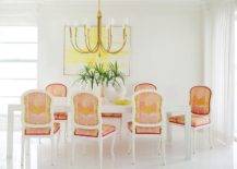 white pink and orange dining chairs gold chandelier yellow wall art
