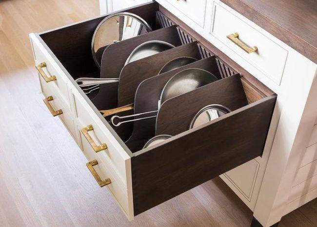 sideways pans stored inside deep drawer kitchen island