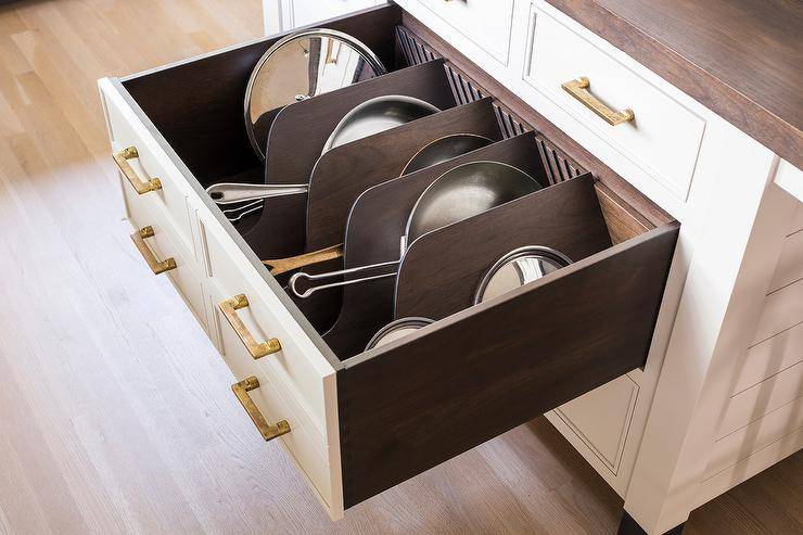 sideways pans stored inside deep drawer kitchen island