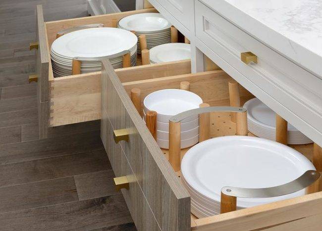 white plates in open drawer peg dividers