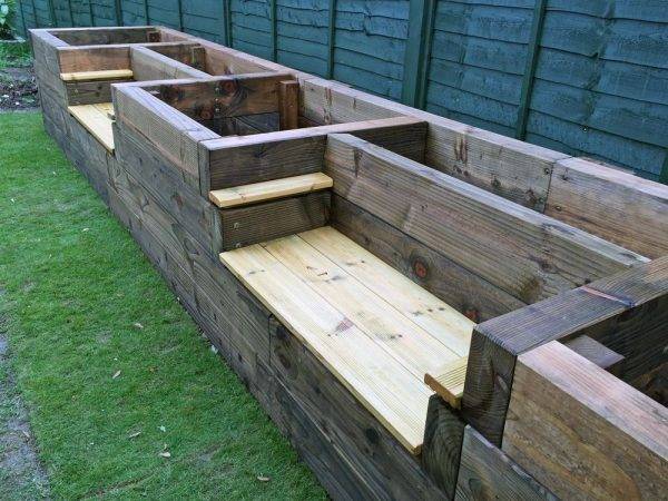 wooden benches with garden beds built in on grass