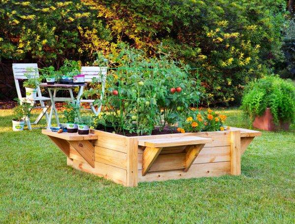 raised garden bed box with benches attached chair and table bistro set in background