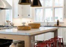 red stools in a black and white kitchen hanging pendants island large window