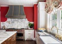 red and white kitchen with gray oven hood large stainless steel stove brown island