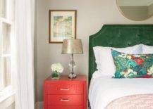 red nightstand olive green velvet headboard pattern pillow table lamp wall art bedroom