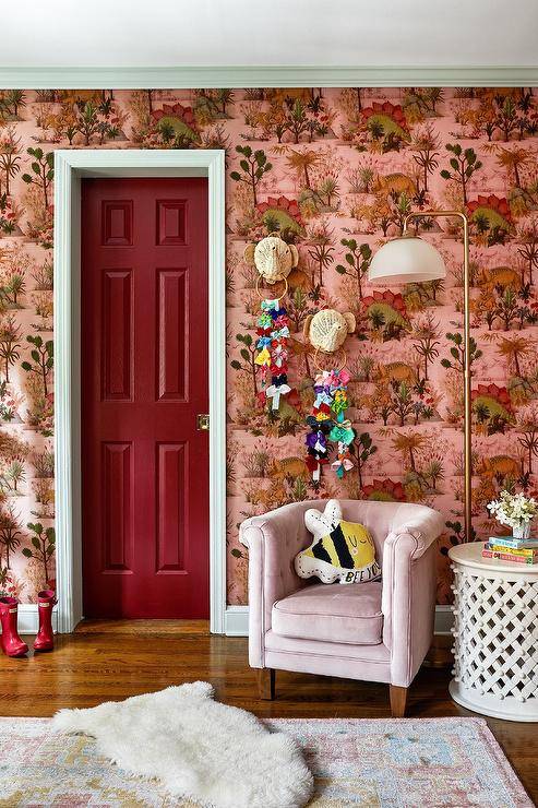 Red and Pink dinosaur wallpaper deep red door with white trim pink child's chair toys