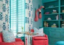 turquoise living room with flamingos hanging on wall sitting chairs bookshelf drapery window