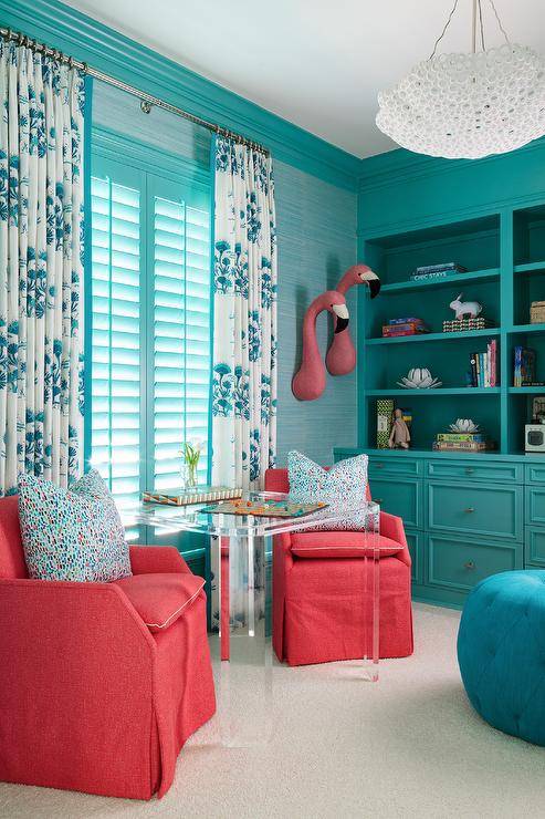 turquoise living room with flamingos hanging on wall sitting chairs bookshelf drapery window 