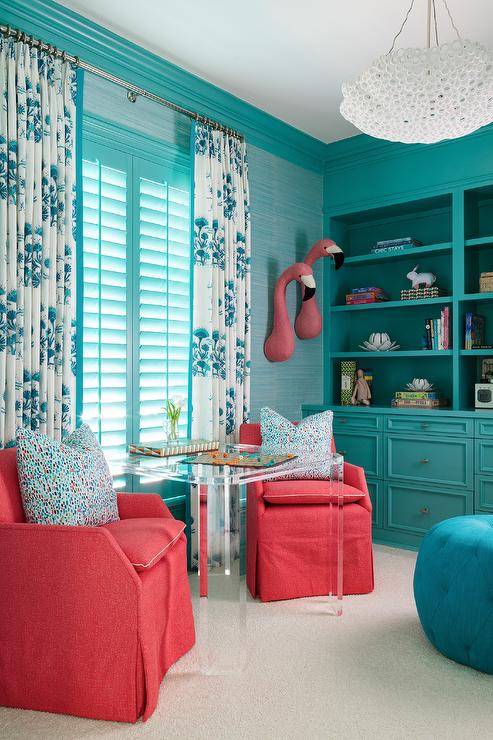 turquoise living room with flamingos hanging on wall sitting chairs bookshelf drapery window