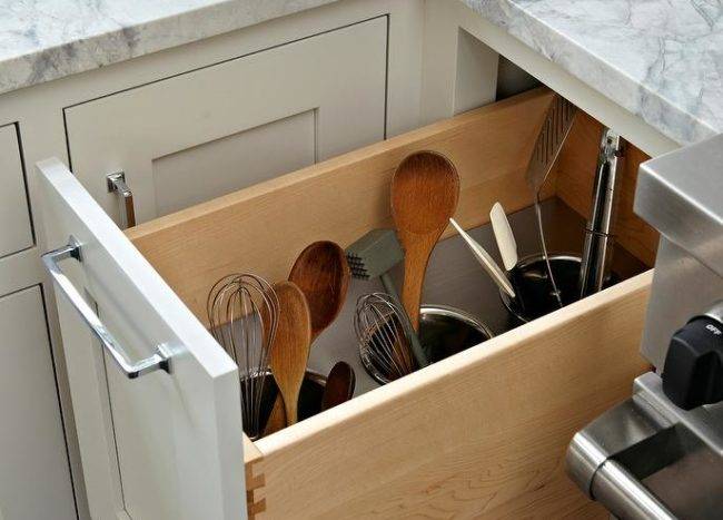 wooden spoons spatulas and whisks stored secretly inside drawer holder marble countertop