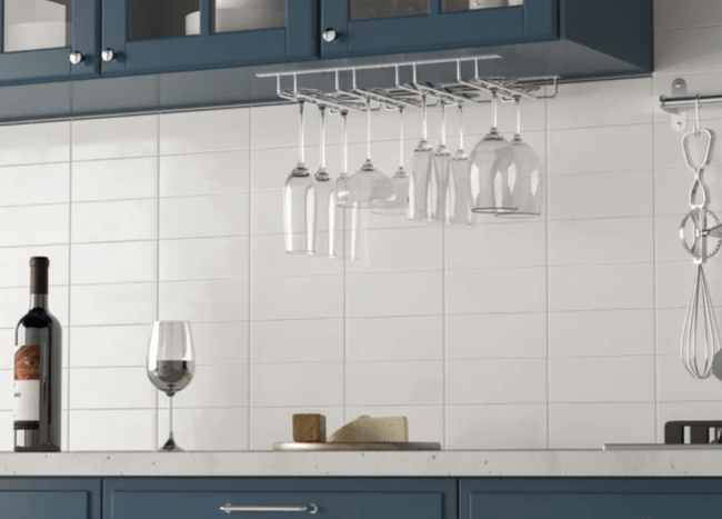 hanging wine glass holder under cupboard blue cabinetry