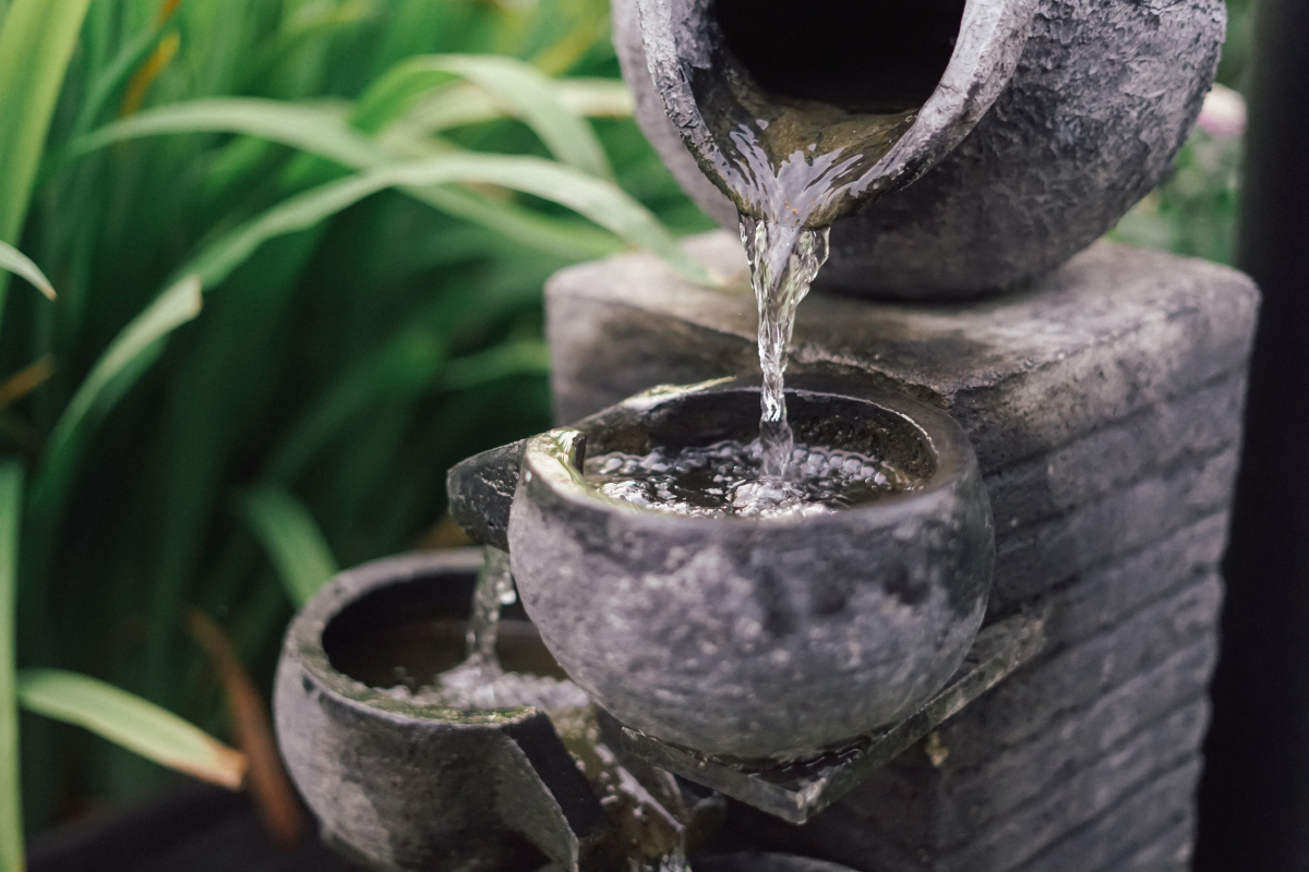 water fountain clay pots close up with water dripping down