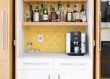 open cupboard with liquor yellow wallpaper background coffee maker