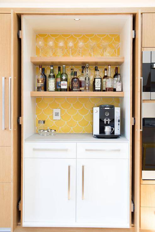 open cupboard with liquor yellow wallpaper background coffee maker