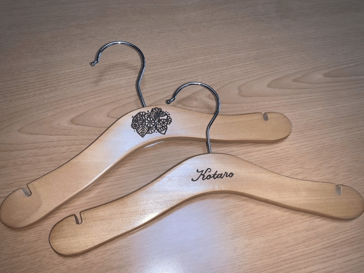 wood burnt clothes hangers on wood floor background