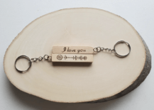 wood keychain on wood log slice white background