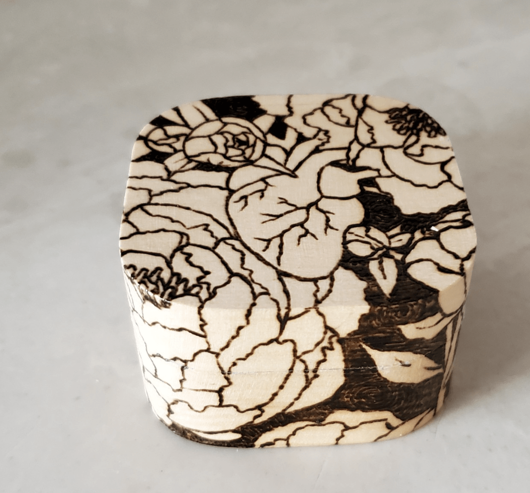wood burnt box with flowers on white background