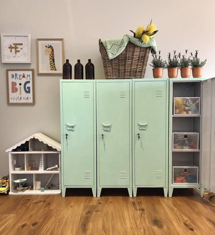 mint green child size lockers in a kids toy room with toys doll house
