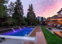 backyard pool deck wood fountain features trees back of house