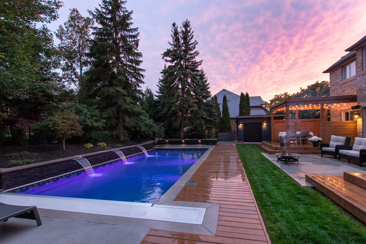 backyard pool deck wood fountain features trees back of house