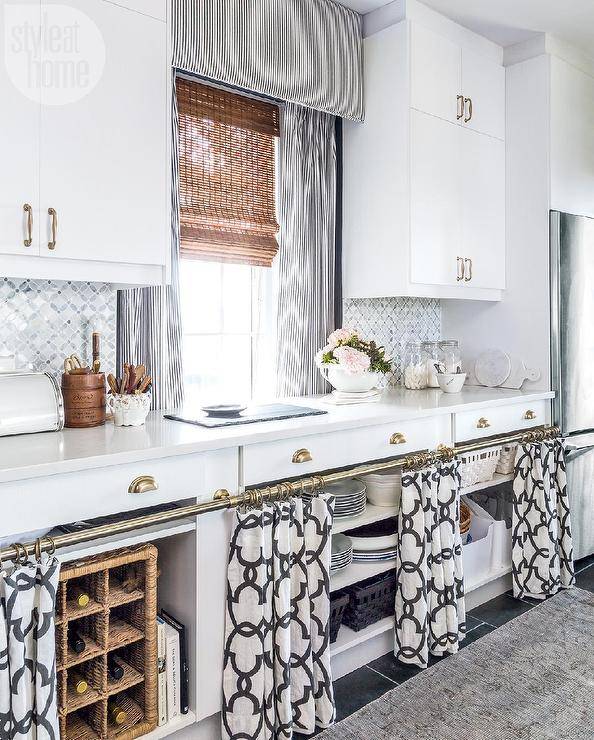 black and white kitchen featuring slate tiled floors black and white kitchen featuring slate tiled floors gray runner curtains lower shelfs bamboo shade