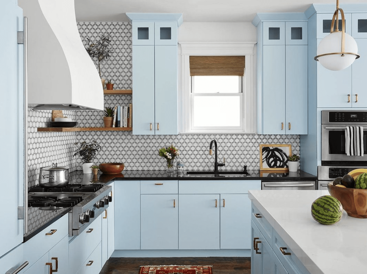 blue kitchen cabinetry patterned tile back bamboo shadessplash white globe hanging pendants white range hood