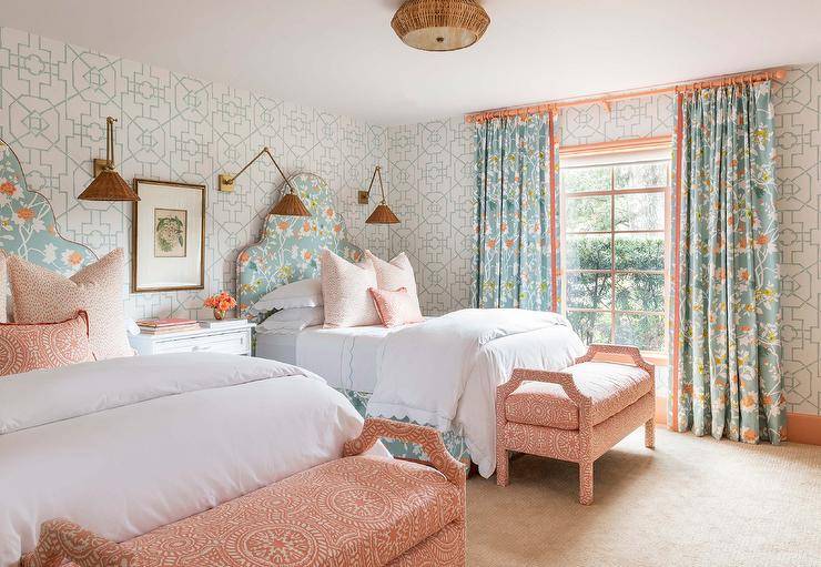 Orange and blue shared bedroom features orange and blue French headboards fitted behind beds topped with orange pillows and paired with orange suzani benches