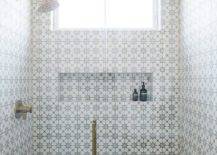 walk-in shower cement tiles floating tiled bench fixed over a gray grid floor and on a wall adjacent to a long tiled niche fixed beneath a window.