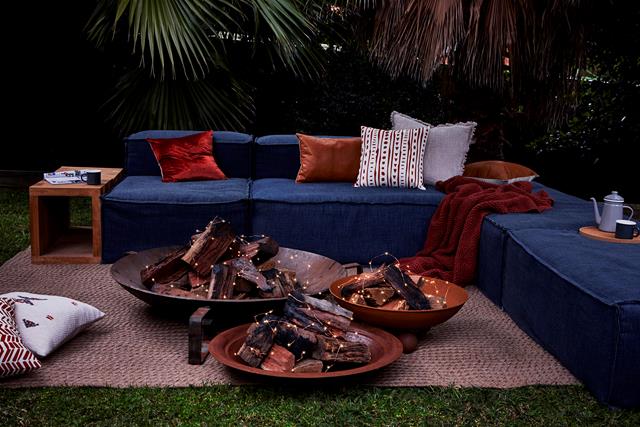 fire pit with fairy lights in the middle blue sectional outdoor couch