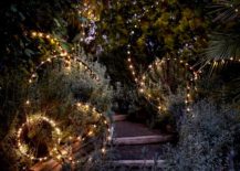 Fairy lights on hula hoops rings in garden path lit up at night