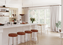 large white kitchen island with leather backless stools large window with floor to ceiling curtains