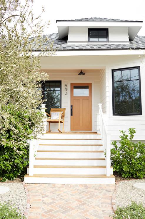 front of house with craftsman style white siding wood door