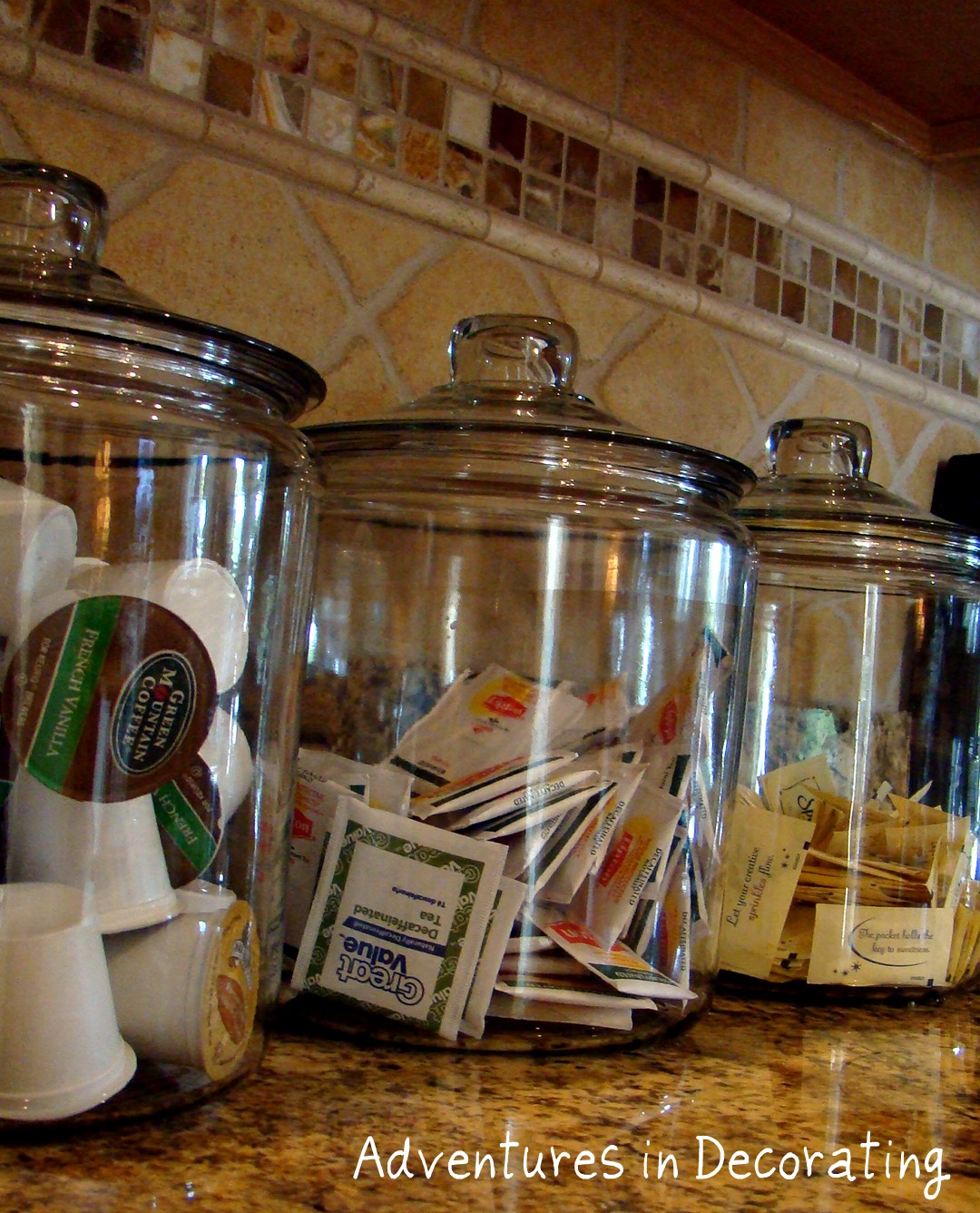 glass large apothecary jars on counter with tea and sugar