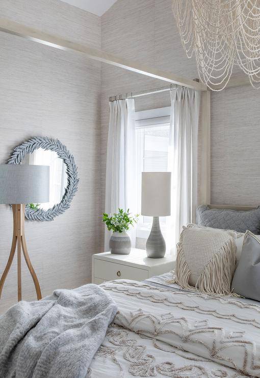 gray and cream theme bedroom with wall mirror post bed with chandelier