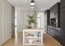 end of kitchen island with decorative shelving black cabinetry