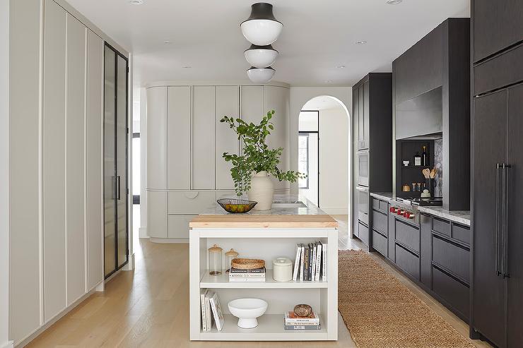 end of kitchen island with decorative shelving black cabinetry