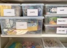 plastic toy storage bins with white labels