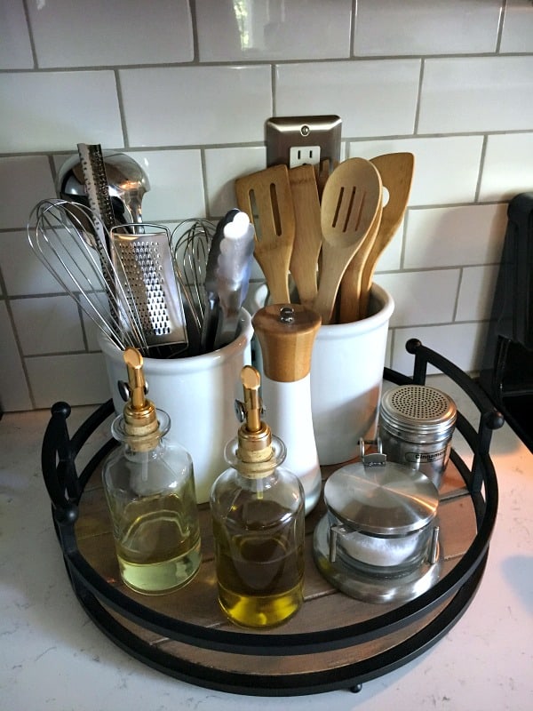 lazy susan with crock containers oil and vinegar wooden utensils