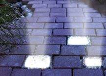 lit up concrete stones on garden path at night shining up