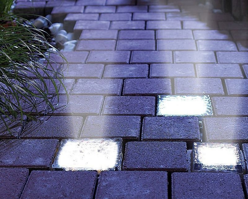 lit up concrete stones on garden path at night shining up